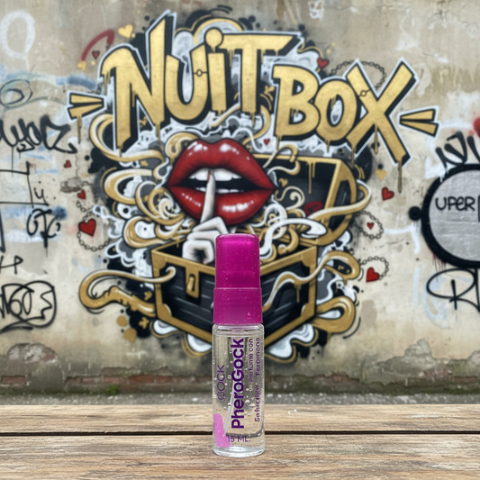 Perfume de feromonas sobre mesa, mural NUIT BOX de labios y grafitis al fondo, sex shop online.